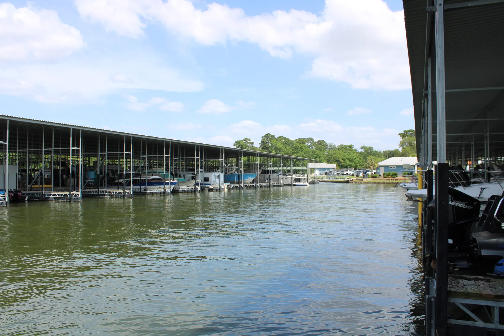 Covered boat slips over the calm water of The Palms Marina on Lake Conroe