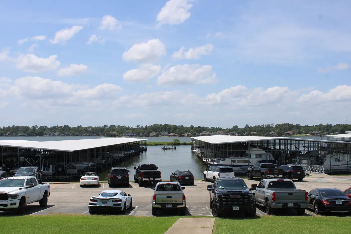 Covered boat slips and boats at The Palms Marina with Lake Conroe beyond