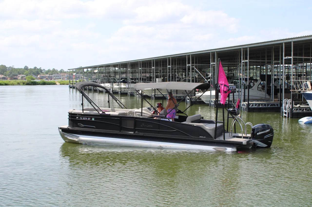 A pontoon boat in its covered slip